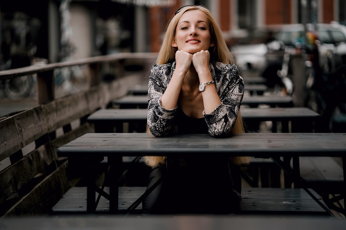 Woman sitting at an outdoor cafe table