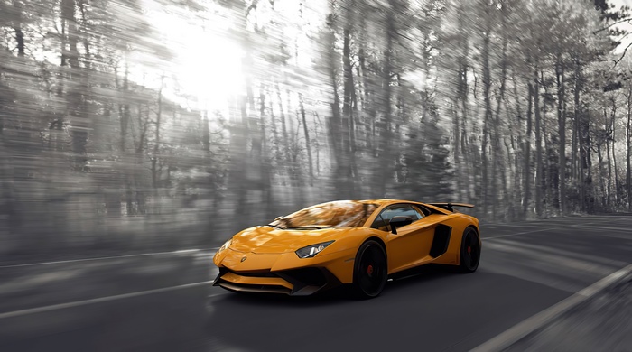 Yellow Lamborghini Aventador driving on a road