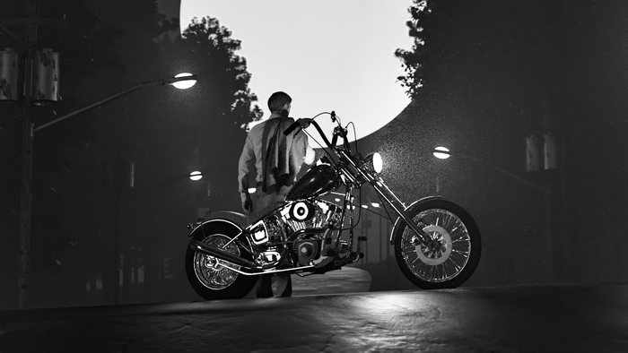 Man and motorcycle under a large moon