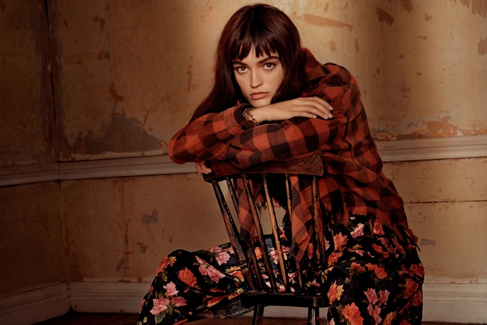 Emma Mackey sitting on a chair