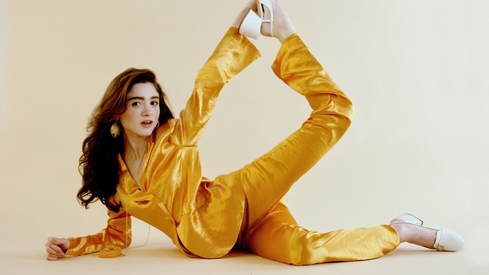Natalia Dyer in a yellow satin suit