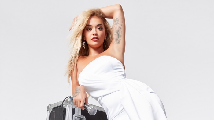 Rita Ora with microphone and equipment case