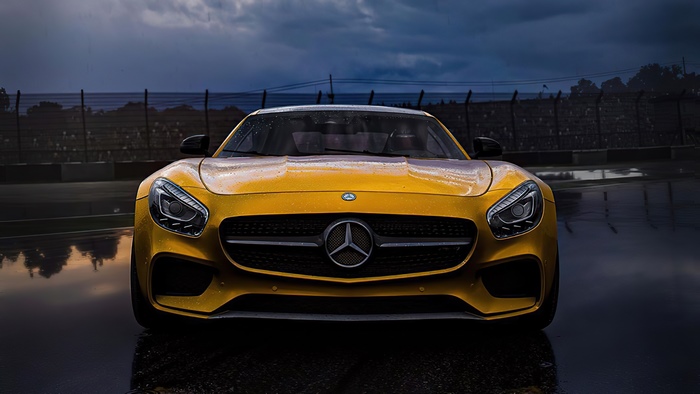 Yellow Mercedes-Benz AMG GT on a wet race track