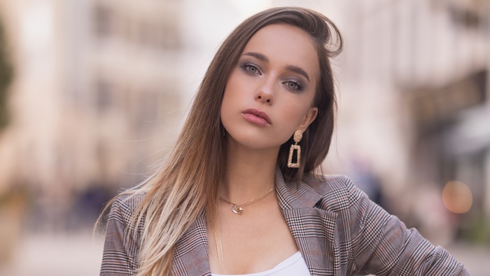 Model with blonde hair wearing a plaid jacket