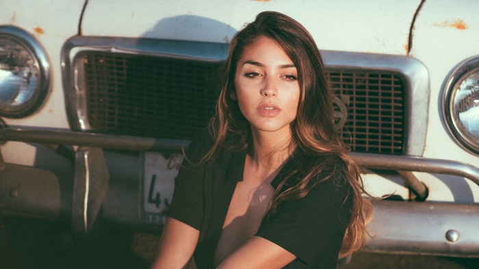 Celine Farach in front of an old car