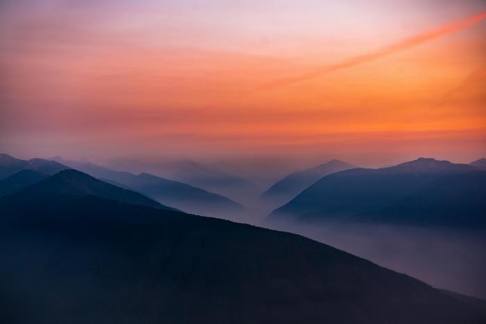 Sunset over misty mountains in a national park