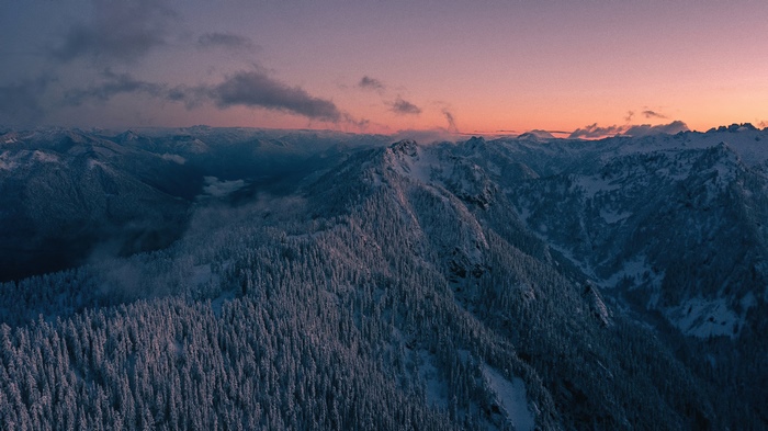 Snow-covered mountains at sunset 4K
