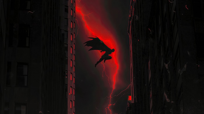 Batman flying through red lightning between buildings