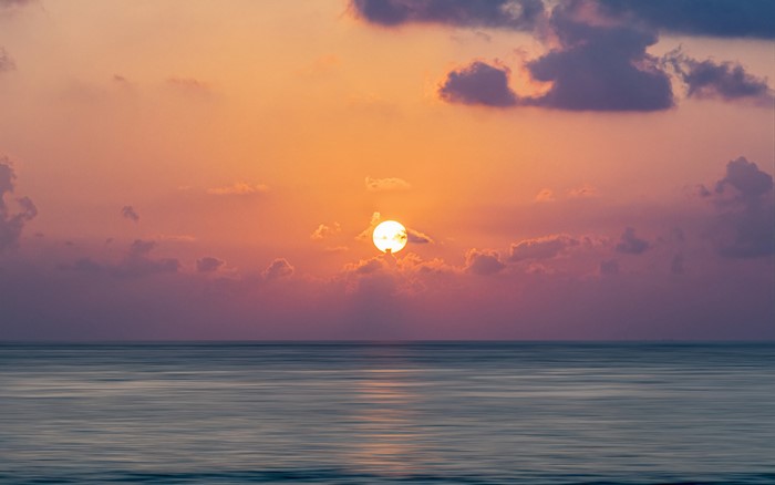 Sunrise over the ocean with clouds