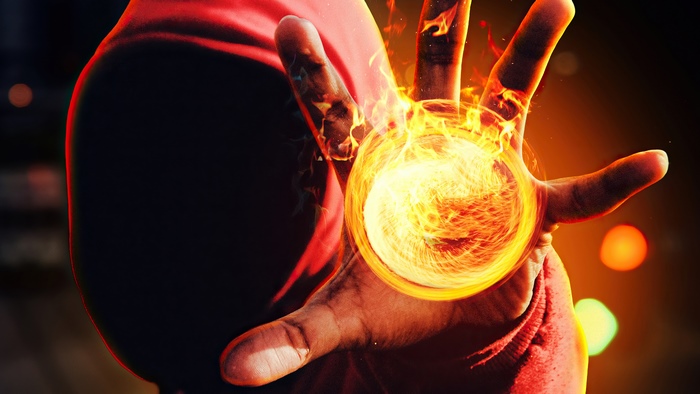 Hand conjuring a fiery orb