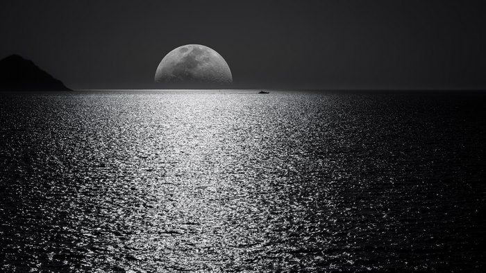 Moon over the ocean at night, black and white 4K