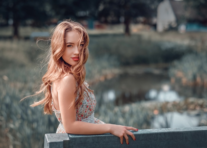 Woman with long wavy hair in a floral dress