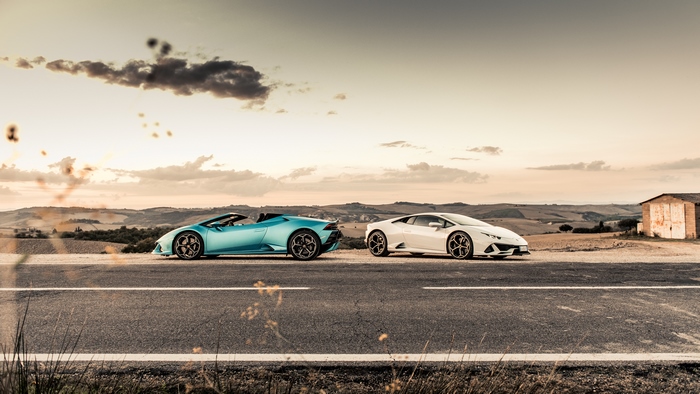 Two Lamborghinis on a road in Tuscany