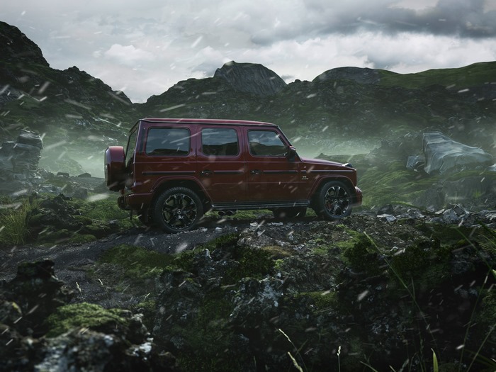 Red Mercedes G-Class SUV in a rocky, mountainous landscape