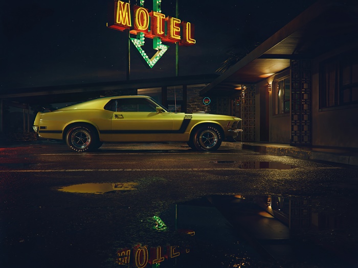 Yellow Ford Mustang Boss 302 at a motel at night