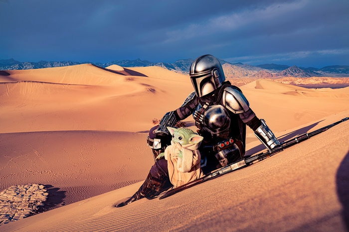 The Mandalorian and Grogu in a desert landscape