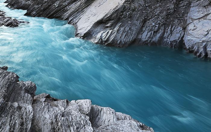 Turquoise river flowing through rocky canyon