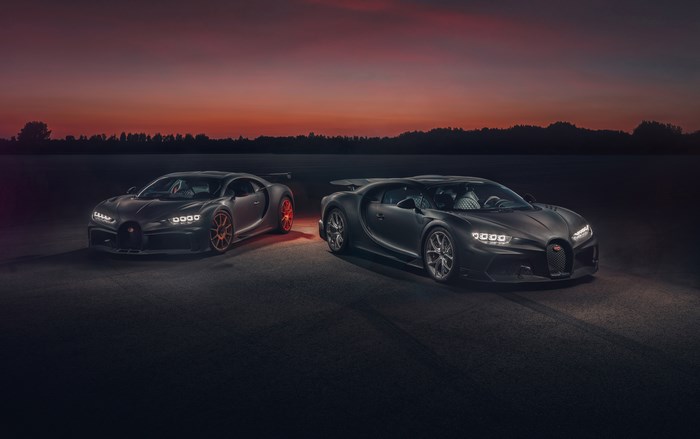 Two Bugatti Chiron cars at sunset