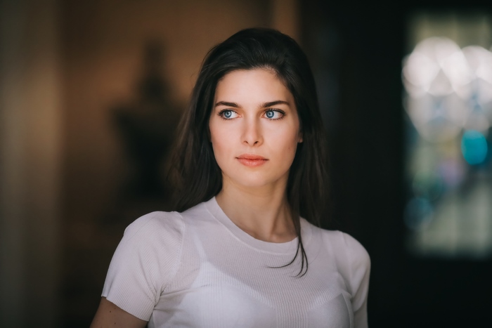 Model with blue eyes wearing white shirt