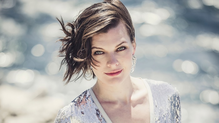 Milla Jovovich posing by the water