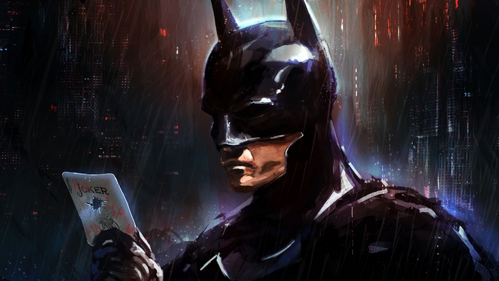 Batman holding a Joker card in Gotham City