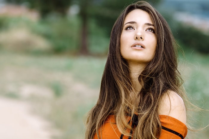 Girl looking up in an orange dress