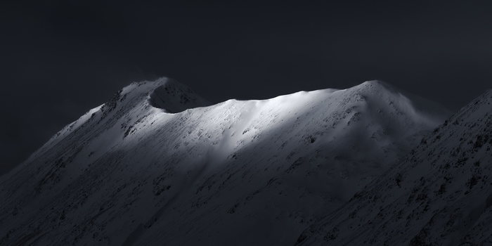 Snow covered mountains in dramatic lighting 4K