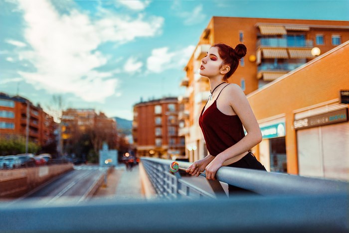 Girl with lollipop on balcony