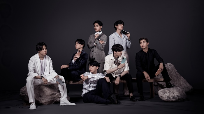 BTS members posing with Samsung Galaxy phones