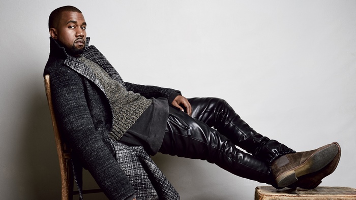 Kanye West sitting on a chair