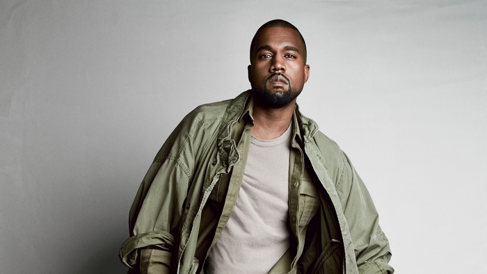 Kanye West wearing a green jacket and tan shirt