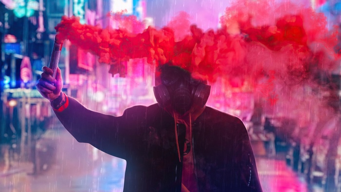 Person with gas mask holding red smoke flare in city
