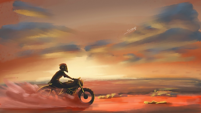Motorcyclist riding through a desert at sunset