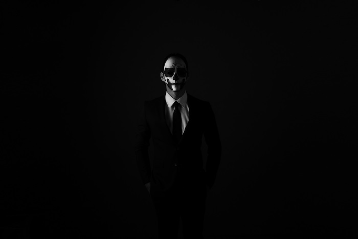 Man in suit with skull face paint
