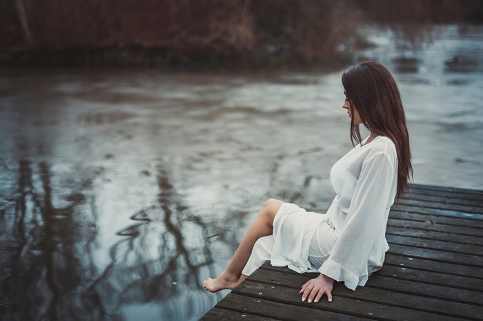 Woman in white dress on a pier