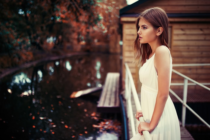 Girl in white dress by the water
