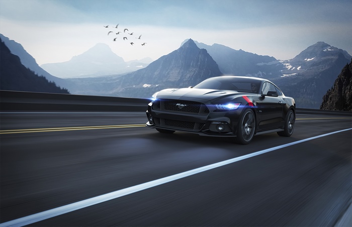 Black Ford Mustang driving on a mountain road
