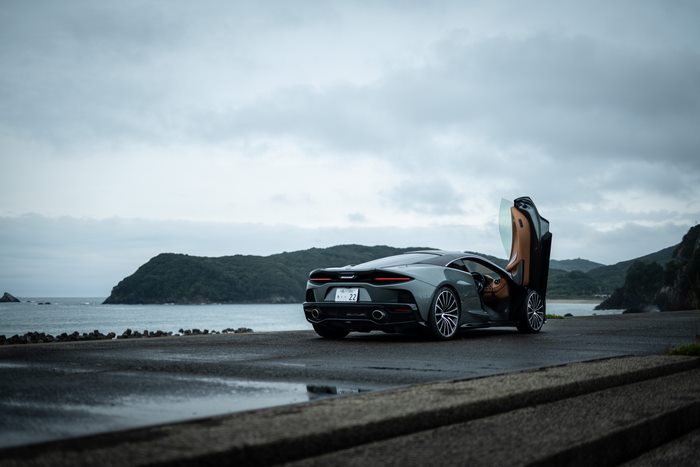 McLaren GT parked by the sea with doors open