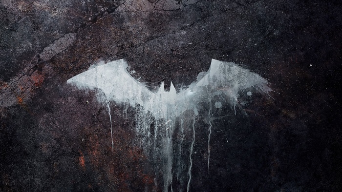 The Batman logo on a textured surface