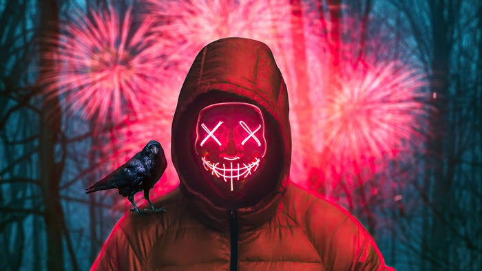 Person in Anonymous Mask with Crow and Fireworks