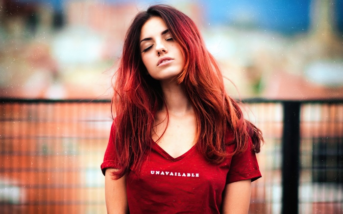 Redhead girl wearing a red t-shirt with "UNAVAILABLE" text