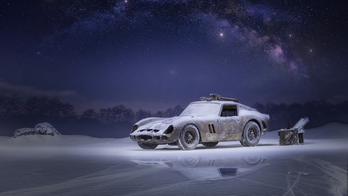Classic car covered in snow under the Milky Way