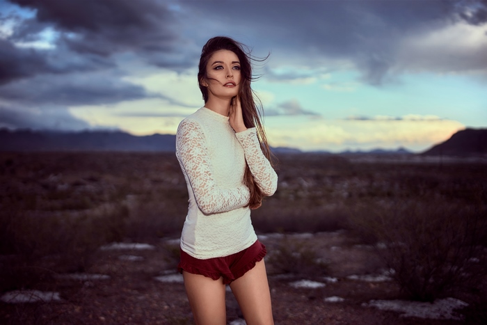 Model in desert landscape at dusk