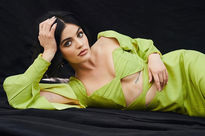 Lucy Hale posing in a green dress