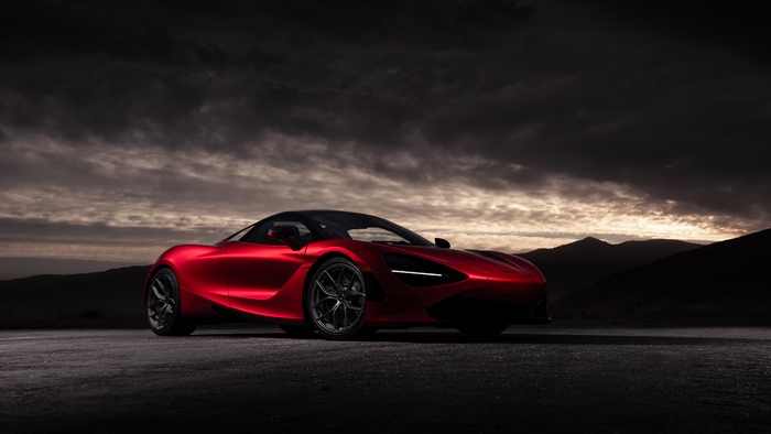 Red McLaren 720S sports car on road