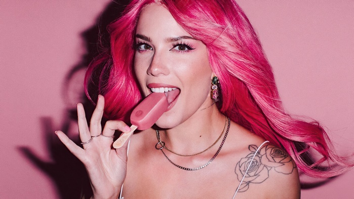 Halsey with pink hair eating a popsicle