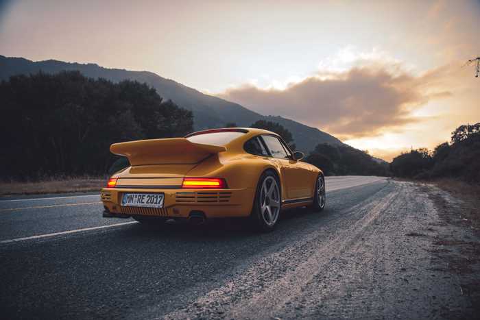 Yellow Porsche 959 on a Road at Sunset
