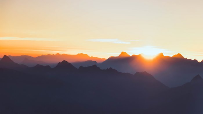 Mountains at sunrise with golden sky
