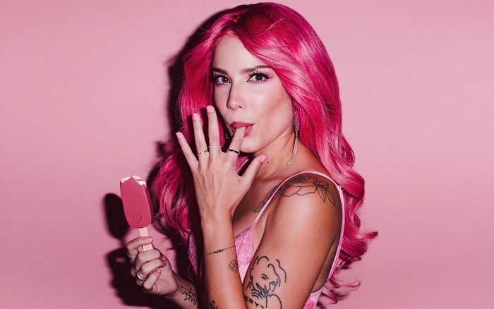 Halsey with pink hair eating an ice cream bar