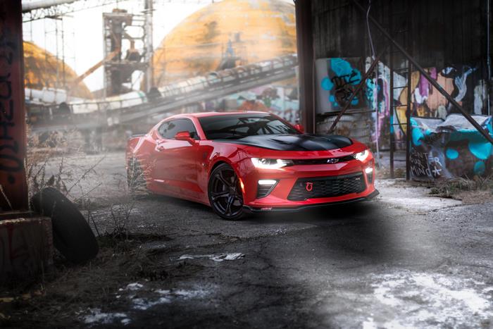 Red Chevrolet Camaro in Industrial Area